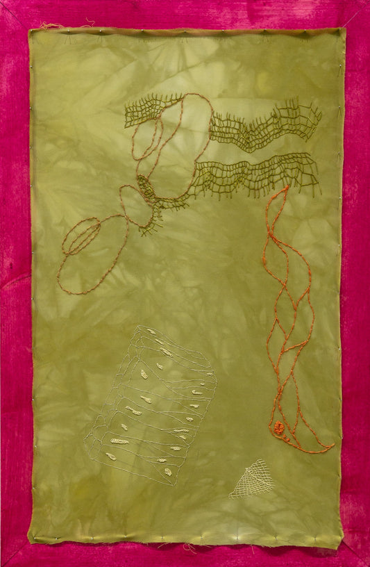 Embroidered artwork on a green fabric with pink border