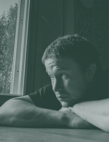 Artistic portrait of a person with a white tank top against a neutral background