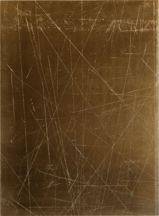 Rectangular bronze metal sheet with scratch patterns on a white background