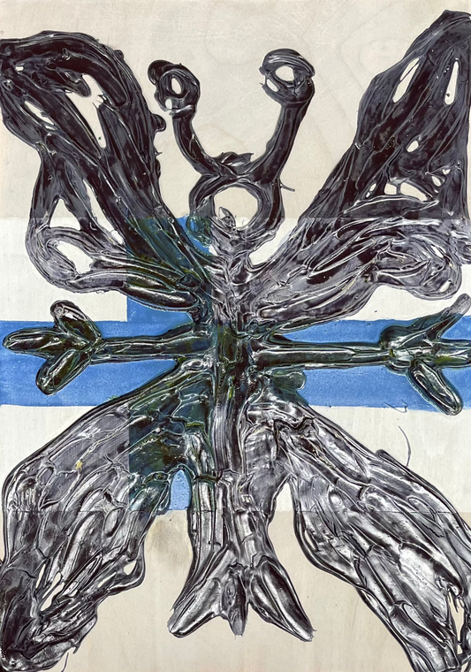 Two abstract artworks on canvas with metallic butterfly design on a wooden surface.