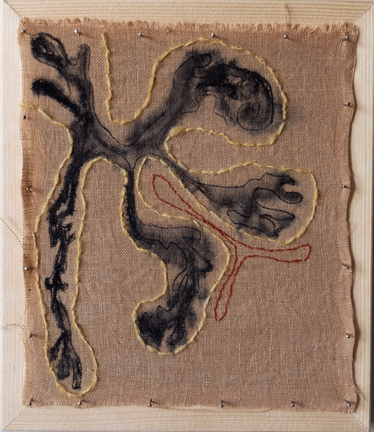 Textile art piece with a stylized figure on a plain background
