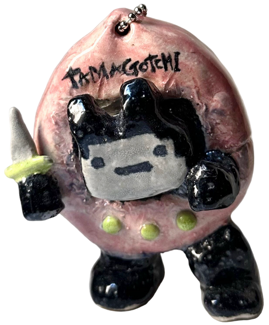 Small figurine with pink body, black limbs, and white face on a white background